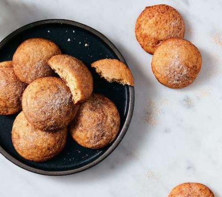 Plate of King Arthur Baking Soft Snickerdoodles Made With Baking Sugar Alternative with one cookie looking like someone is eating it