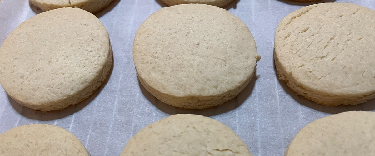 rows of cookies on parchment on cooling rack