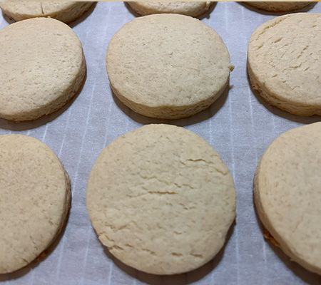 rows of cookies on parchment on cooling rack