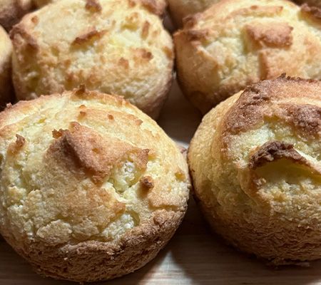 Up close shot of four golden brown muffins