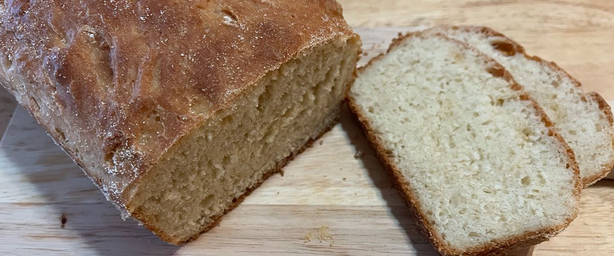 a loaf of bread with two slices next to it