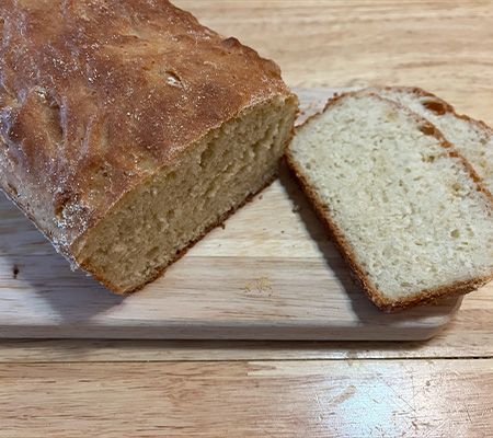 a loaf of bread with two slices next to it