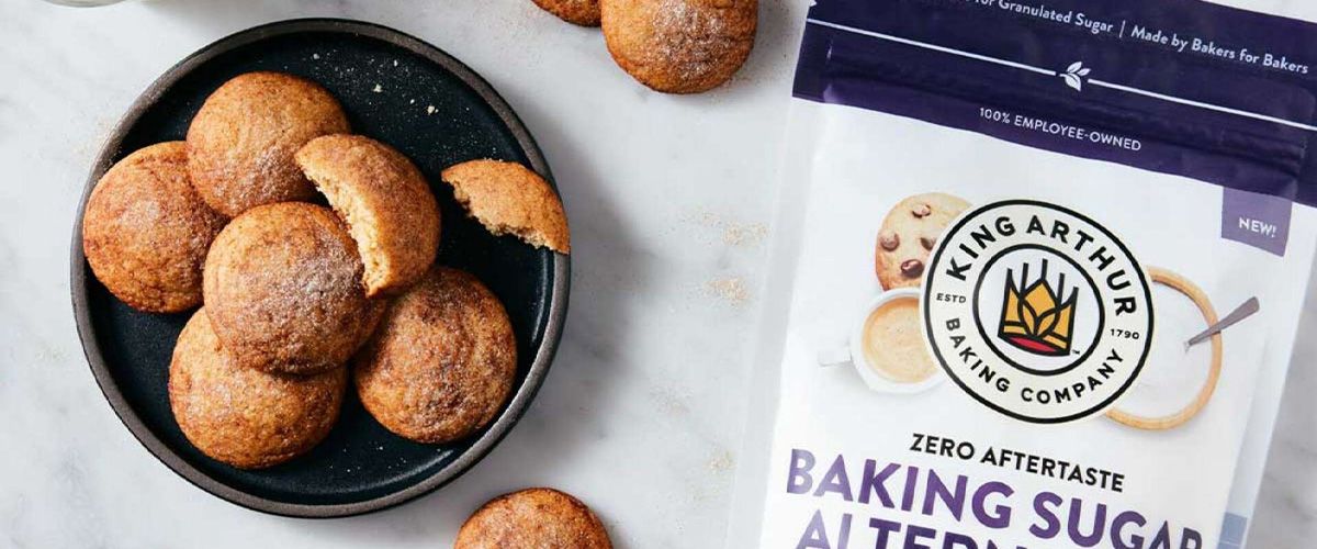 Plate of King Arthur Baking Soft Snickerdoodles Made With Baking Sugar Alternative with one cookie looking like someone is eating it