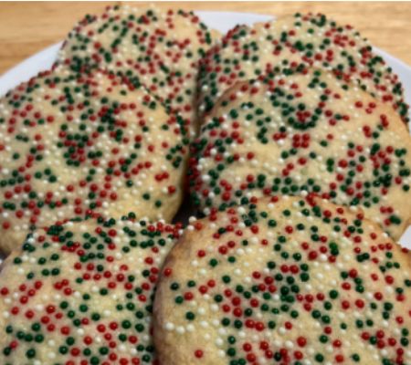 close up of a plate of sprinkle butter cookies